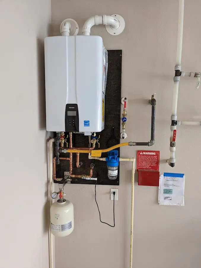 Professional plumber installing copper piping in a Hockessin home